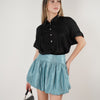 Jeyra Flaca Top – Draped Black Blouse with Modern Ease